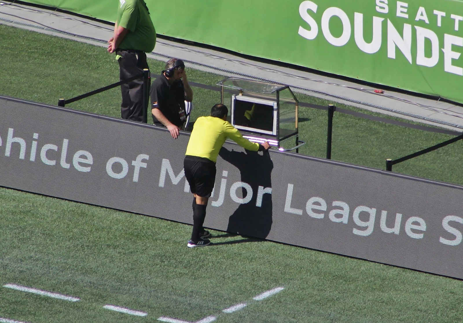 Referee Baldomero Toledo at a pitchside video-review monitor