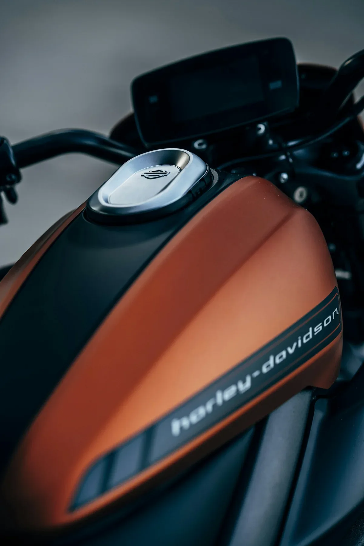 An orange and black Harley-Davidson motorcycle