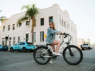 A rider using a KBO electric bicycle on a city street